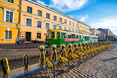 Yellow city bikes lined up on a sunny street